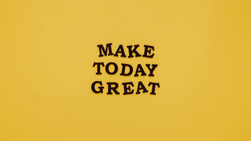 Simple and motivational quote 'Make Today Great' on a minimalist yellow background for inspiration.